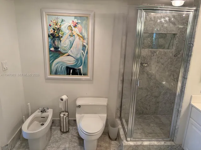 a bathroom with a toilet and a shower
