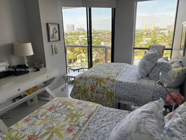 a bedroom with a bed and large window