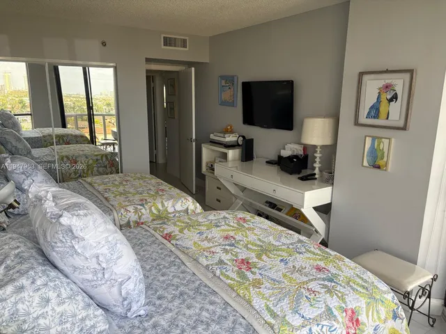 a bedroom with a bed and flat screen tv
