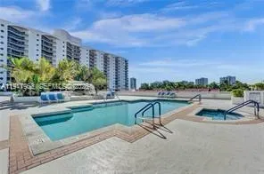 a view of swimming pool with outdoor seating and plants