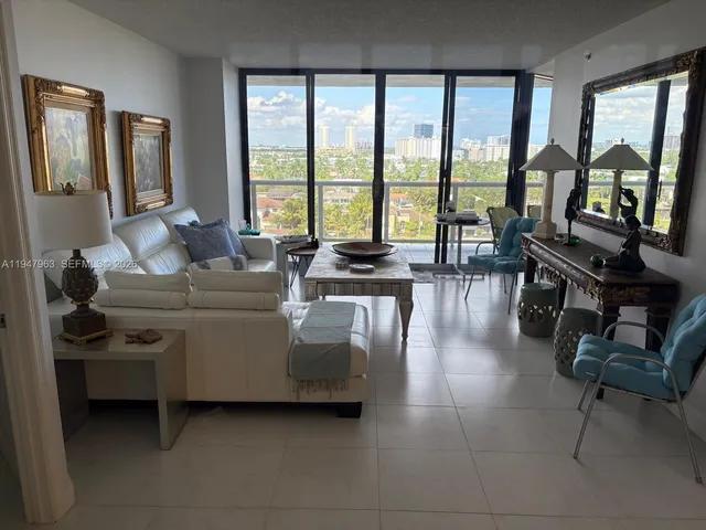 a living room with furniture and large windows