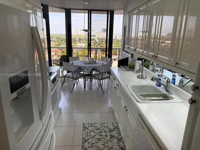 a kitchen with a sink a counter top space and stainless steel appliances