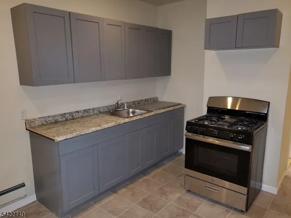 a kitchen with granite countertop cabinets and white stove