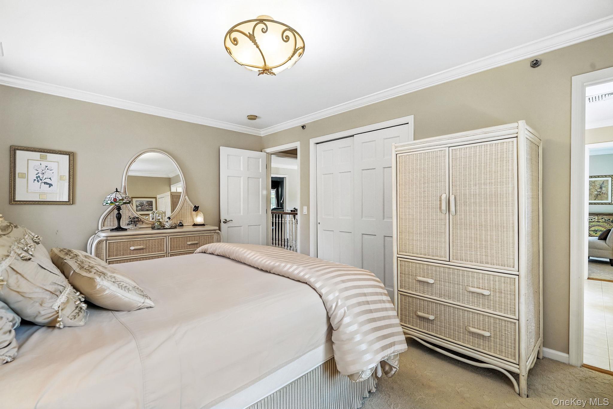 33 Hevelyne Road Elmsford, NY 10523 - Photo 22 of 43 Carpeted bedroom with crown molding and a closet