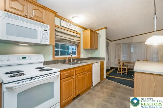 a kitchen with a stove a sink and a microwave