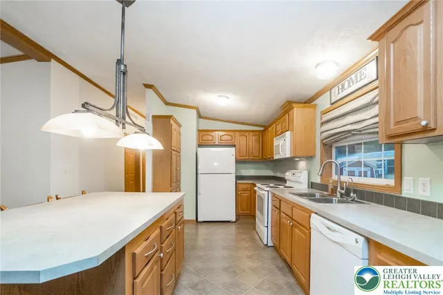 a kitchen with stainless steel appliances granite countertop a sink and a refrigerator