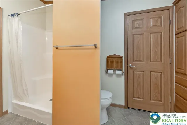 a bathroom with a shower and a toilet