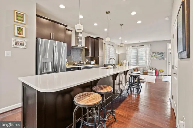 a large kitchen with a table and chairs