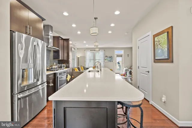 a kitchen with stainless steel appliances a refrigerator sink and stove