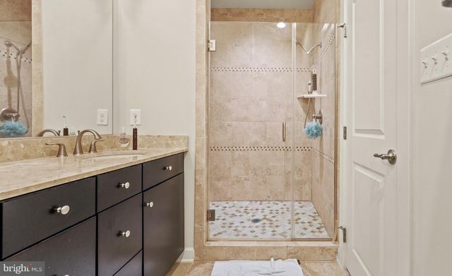 a bathroom with a shower sink and mirror