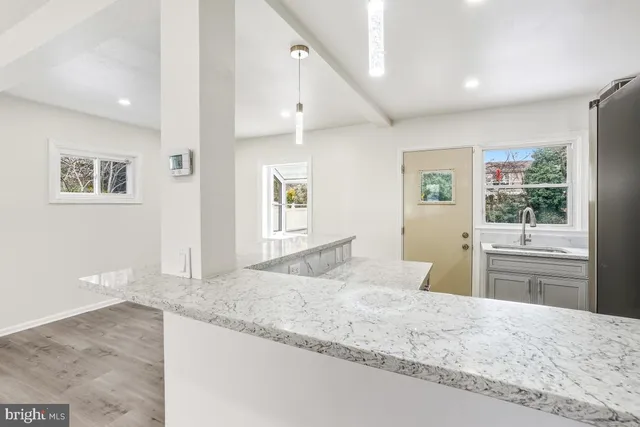 a bedroom with granite countertop cabinets and window