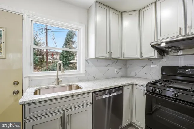 a kitchen with a sink stove and cabinets