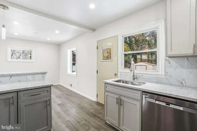 a kitchen with a sink cabinets and window