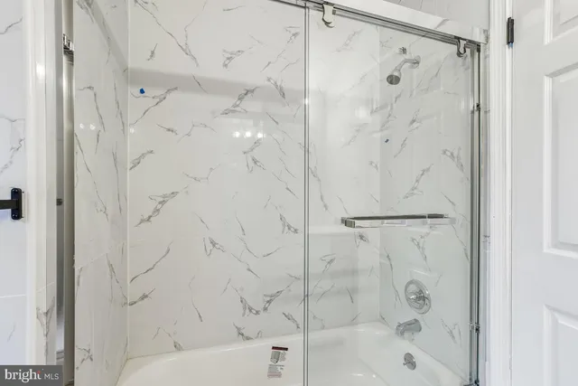 a bathroom with a bathtub and shower