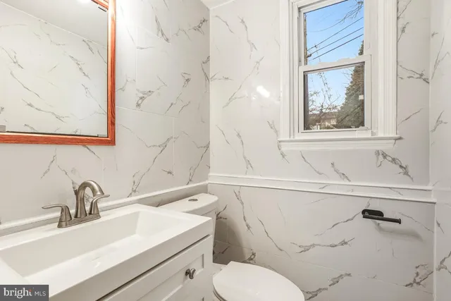a bathroom with a sink toilet and vanity