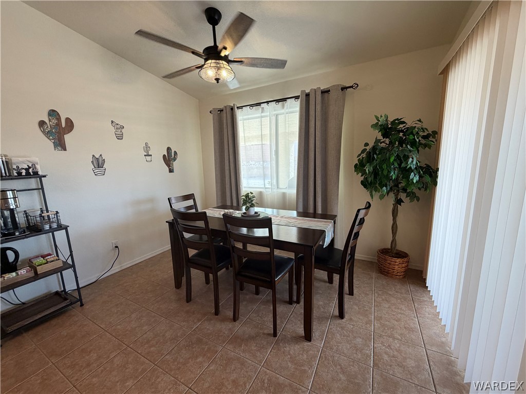 2416 North Ridge Avenue Bullhead City, AZ 86429 - Photo 12 of 33 Tiled dining space with a ceiling fan and lofted ceiling