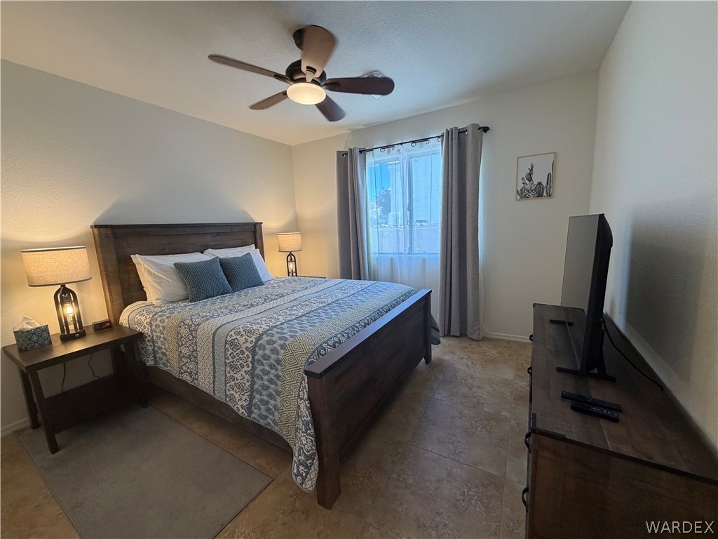 2416 North Ridge Avenue Bullhead City, AZ 86429 - Photo 17 of 33 Bedroom featuring a ceiling fan and baseboards