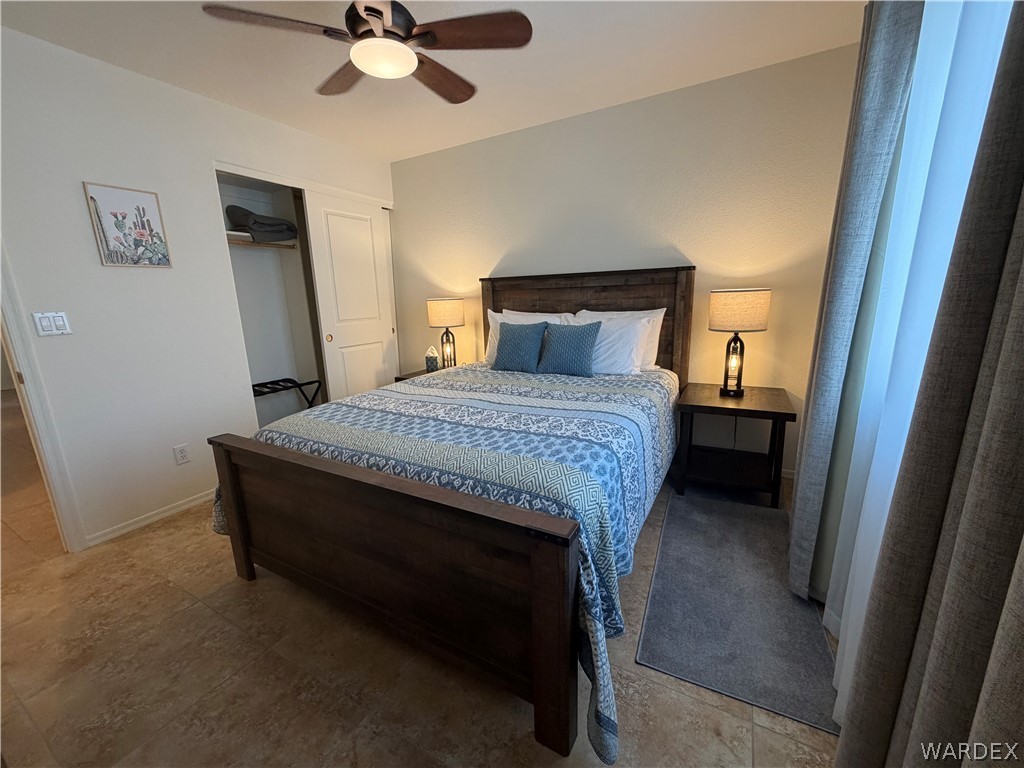 2416 North Ridge Avenue Bullhead City, AZ 86429 - Photo 18 of 33 Bedroom with a ceiling fan and a closet