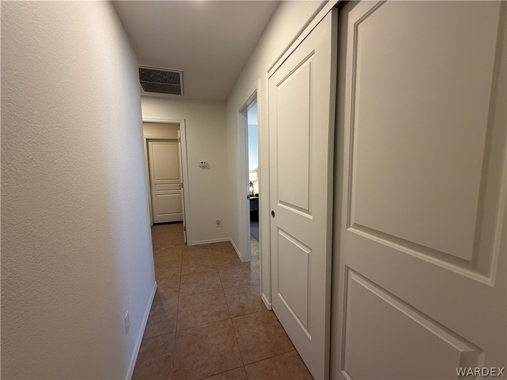2416 North Ridge Avenue Bullhead City, AZ 86429 - Photo 19 of 33 Hall with light tile patterned floors and a textured wall