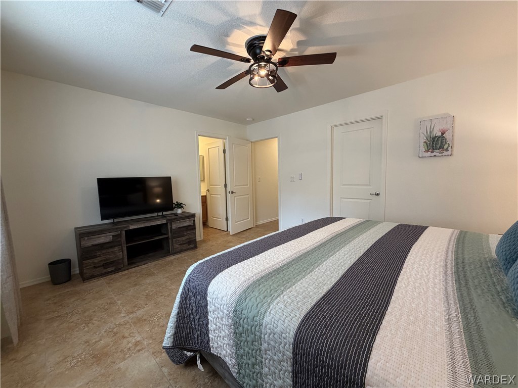 2416 North Ridge Avenue Bullhead City, AZ 86429 - Photo 23 of 33 Bedroom featuring ceiling fan and baseboards