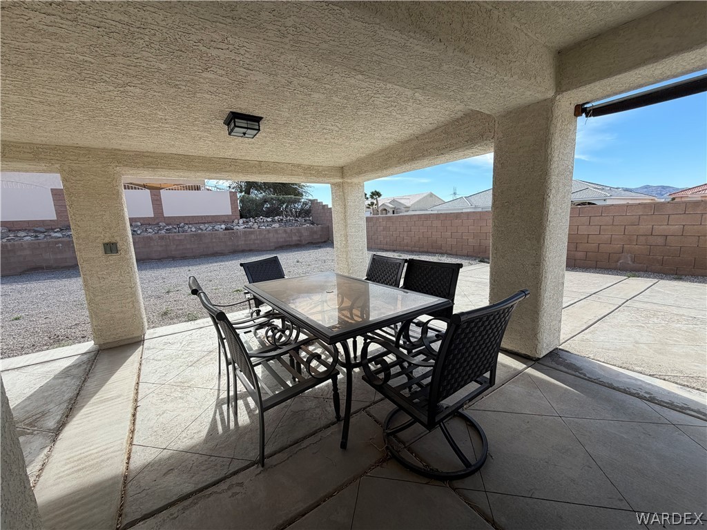 2416 North Ridge Avenue Bullhead City, AZ 86429 - Photo 29 of 33 Fenced backyard featuring a patio area and outdoor dining area