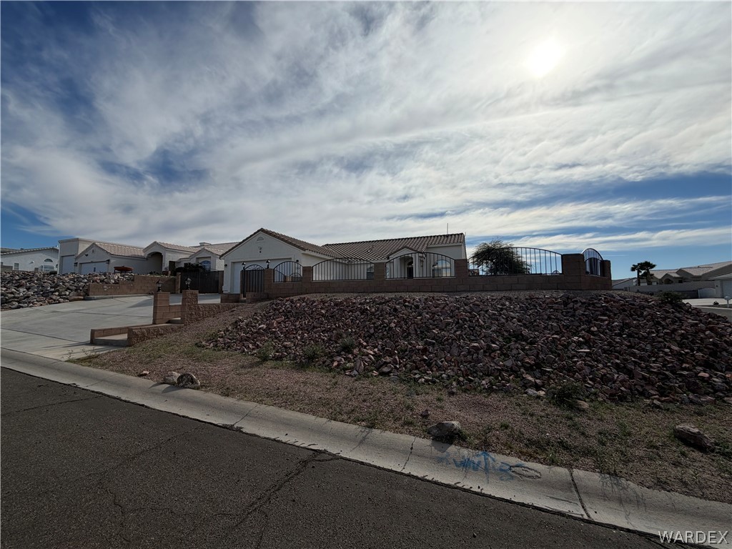 2416 North Ridge Avenue Bullhead City, AZ 86429 - Photo 3 of 33 View of front of house with a fenced front yard and a residential view