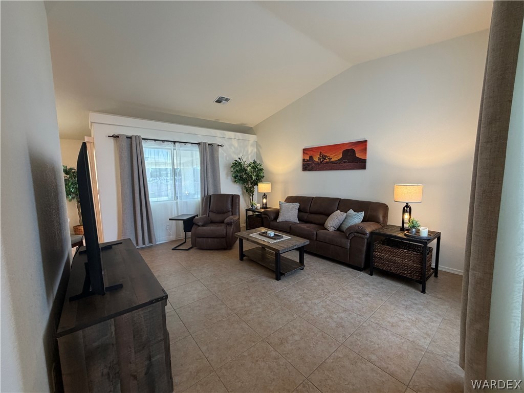 2416 North Ridge Avenue Bullhead City, AZ 86429 - Photo 8 of 33 Living room with light tile patterned floors and lofted ceiling