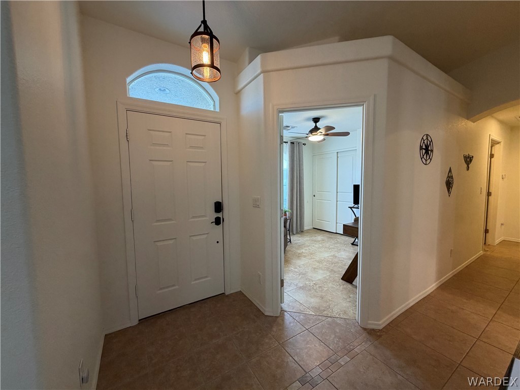 2416 North Ridge Avenue Bullhead City, AZ 86429 - Photo 9 of 33 Foyer with tile patterned flooring, arched walkways, and ceiling fan
