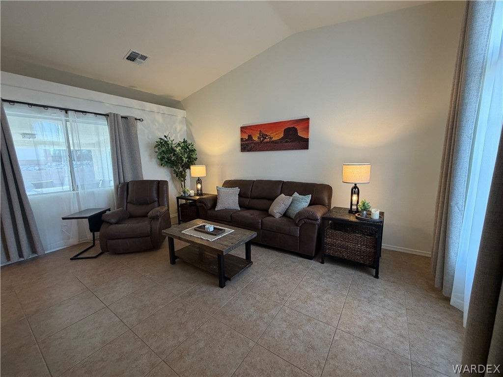 2416 North Ridge Avenue Bullhead City, AZ 86429 - Photo 10 of 33 Living room with lofted ceiling and light tile patterned floors
