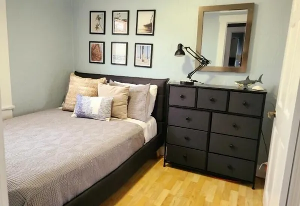 a bedroom with a bed and a dresser