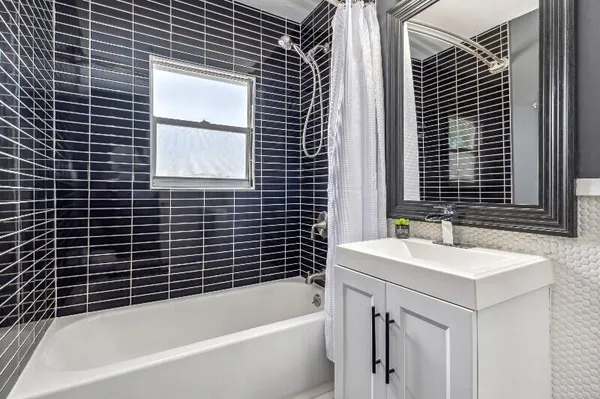 a bathroom with a bathtub and a sink