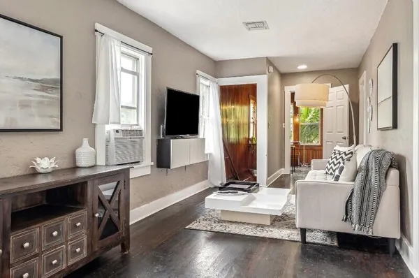 a living room with furniture and a flat screen tv