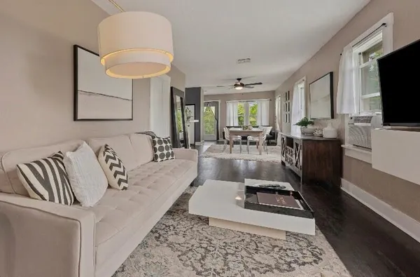 a living room with furniture and a flat screen tv