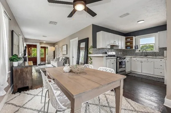 a view of kitchen with cabinets table and chairs