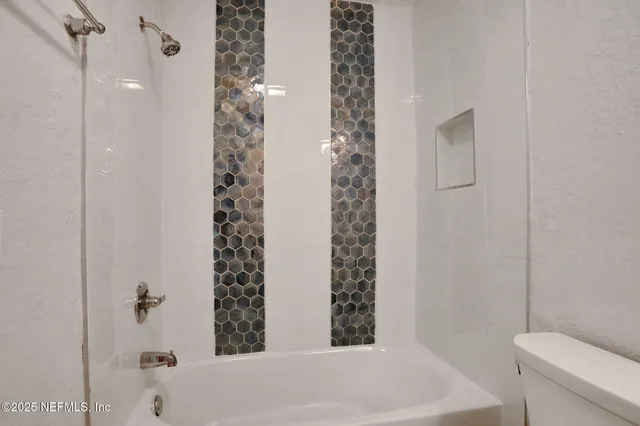 a bathroom with a bathtub and shower