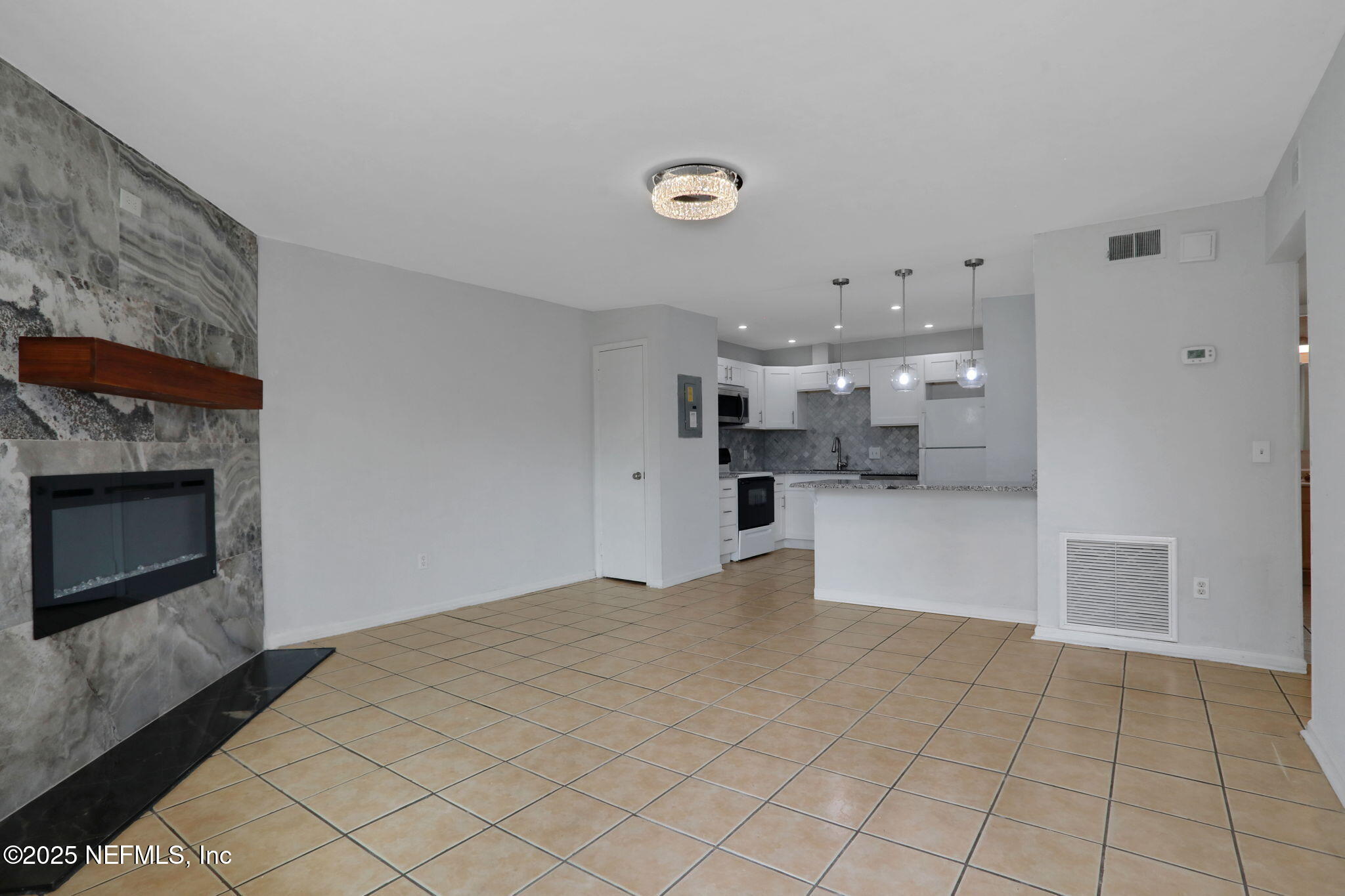 791 Assisi Lane, Unit 1704 Jacksonville, FL 32233 - Photo 4 of 16 a view of a kitchen with furniture and a fireplace