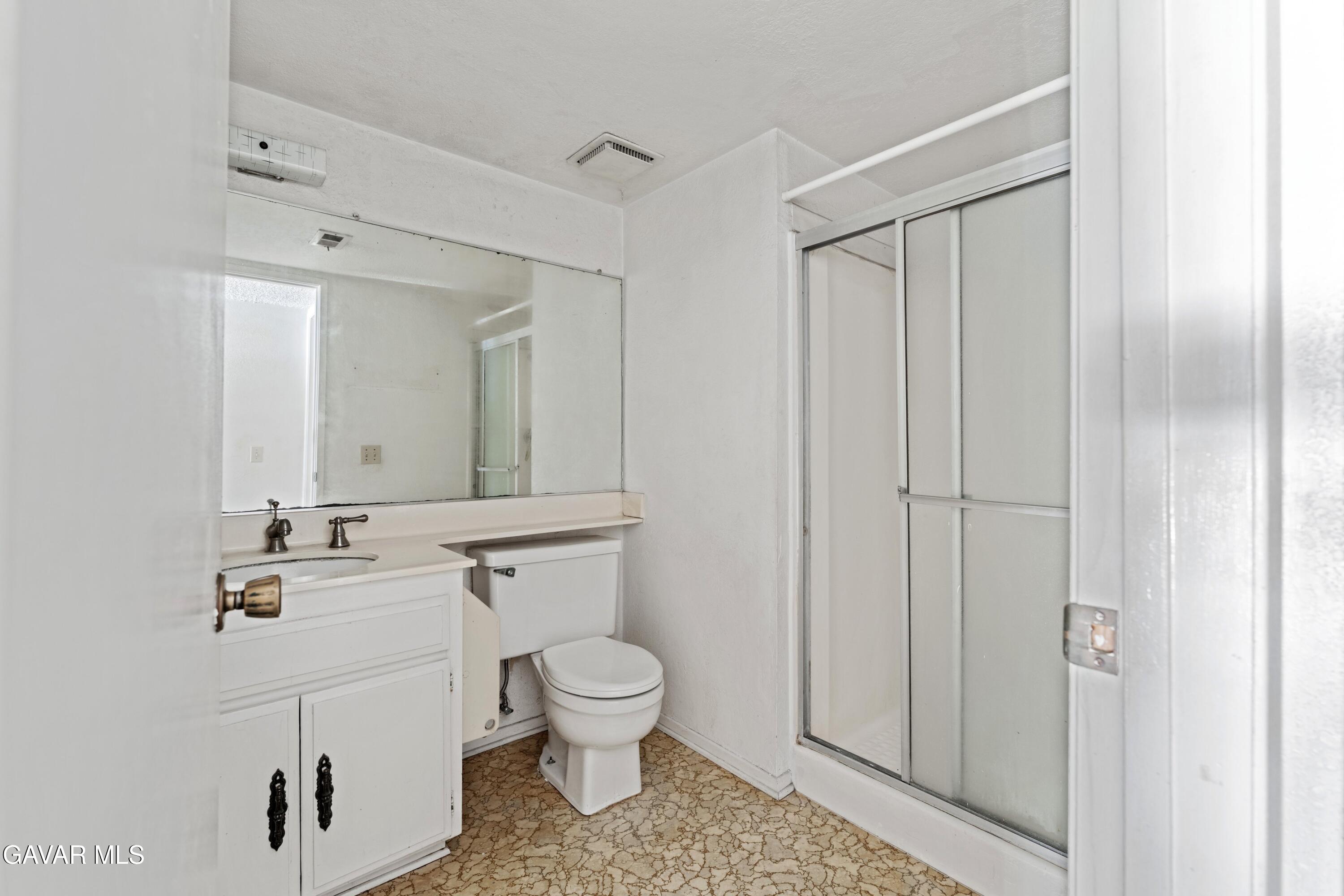 6113 Sard Street Rancho Cucamonga, CA 91701 - Photo 12 of 26 a bathroom with a toilet a sink a vanity and mirror