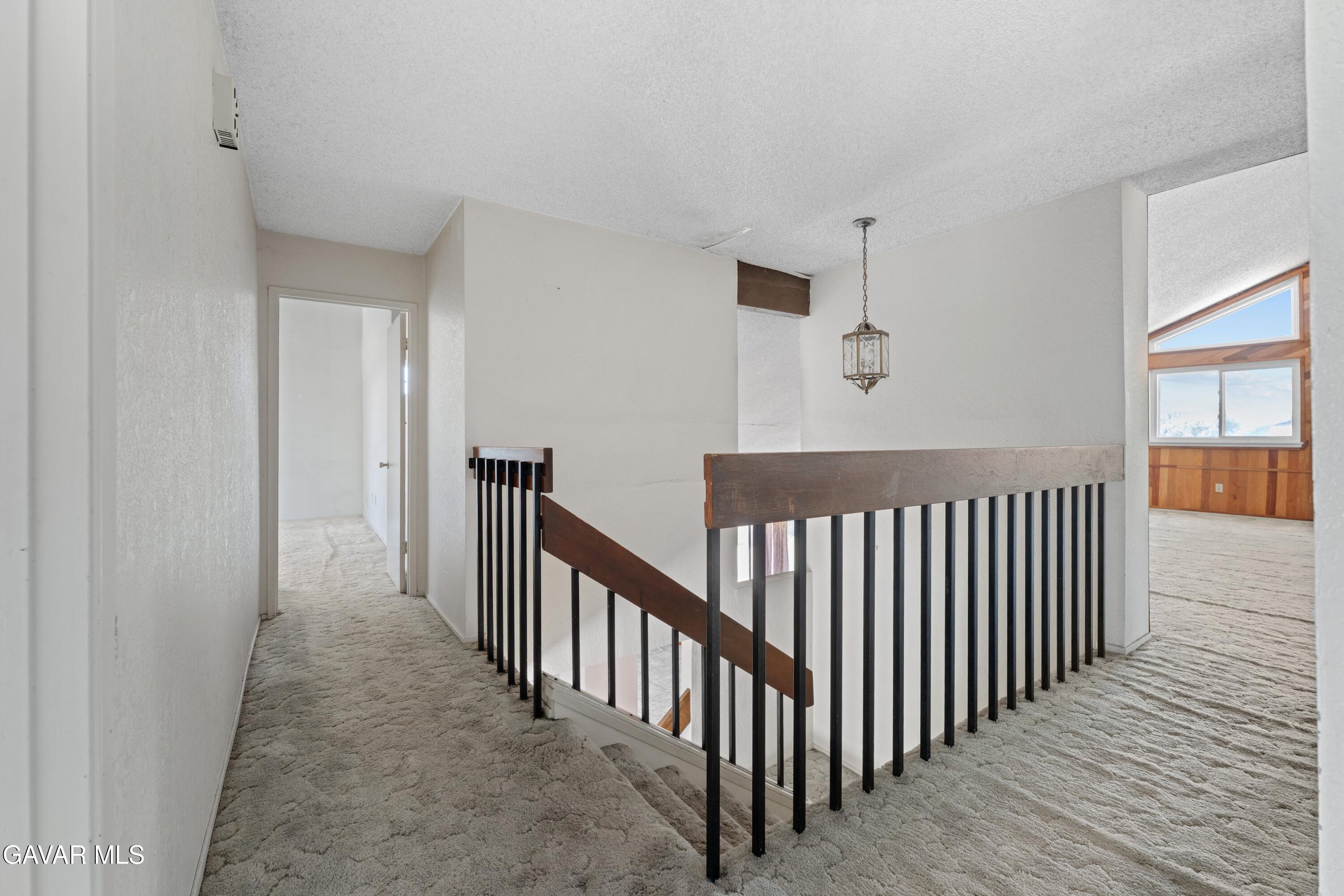 6113 Sard Street Rancho Cucamonga, CA 91701 - Photo 14 of 26 a view of a hallway with wooden floor and windows