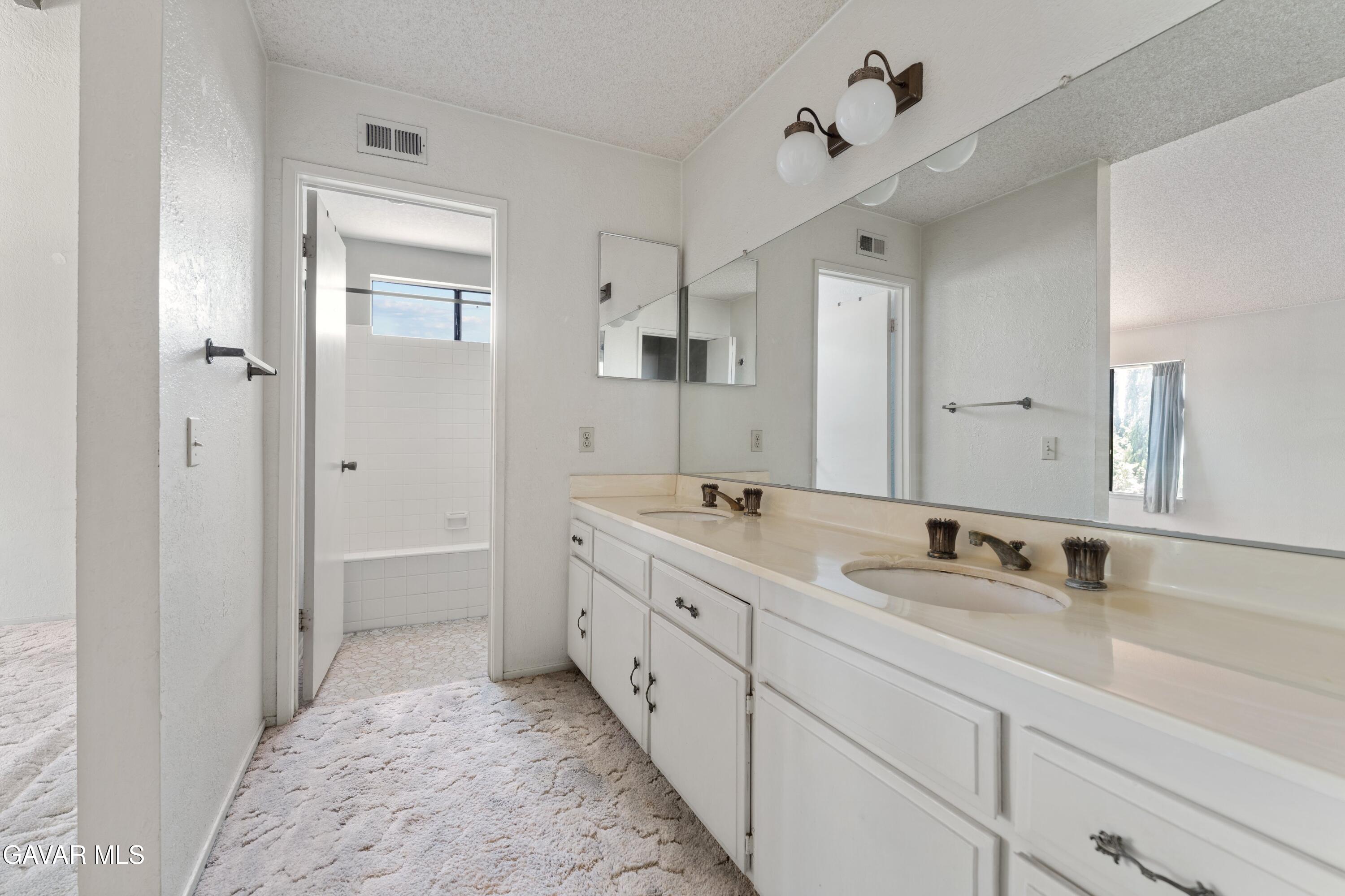 6113 Sard Street Rancho Cucamonga, CA 91701 - Photo 17 of 26 a spacious bathroom with a double vanity sink mirror and