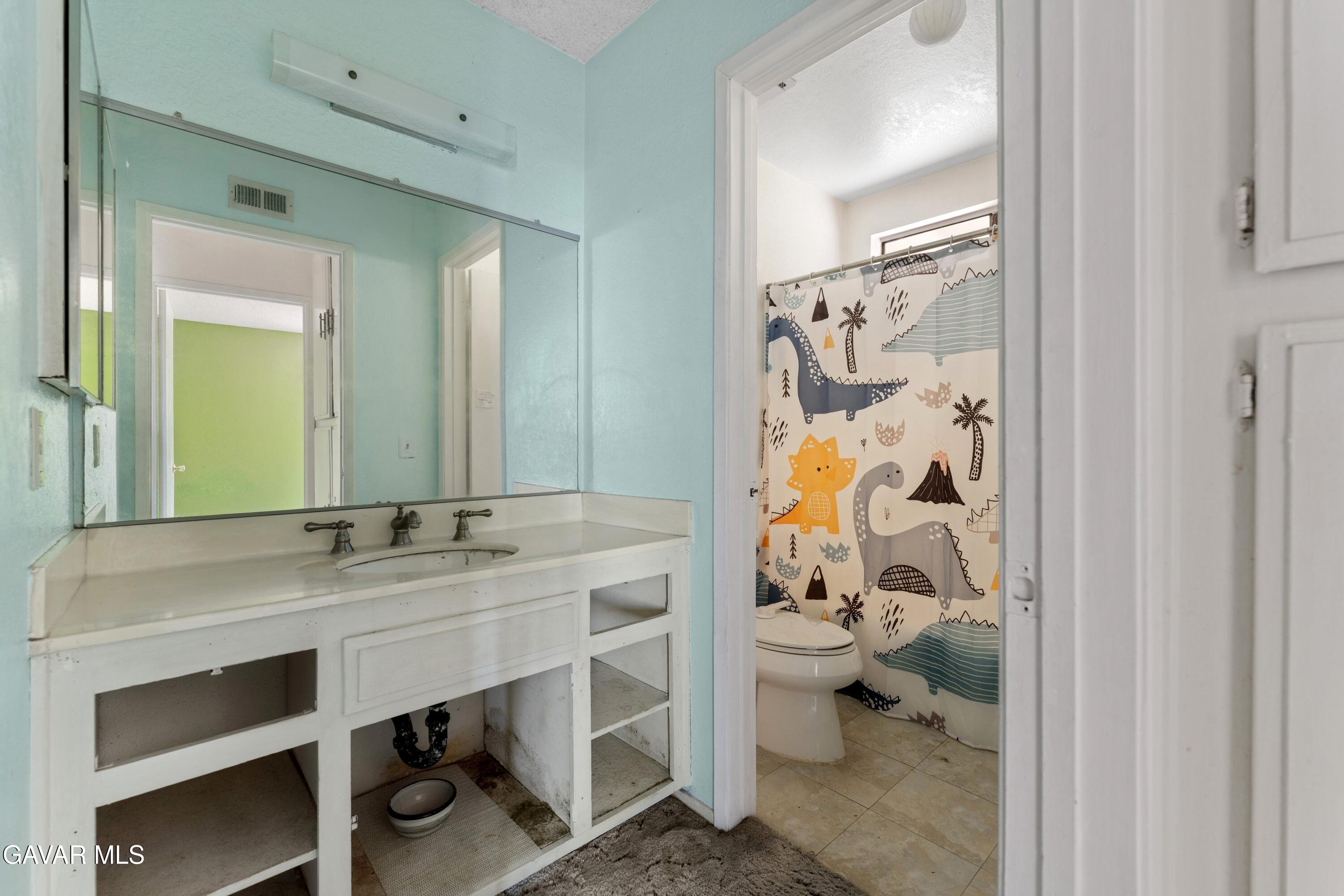 6113 Sard Street Rancho Cucamonga, CA 91701 - Photo 20 of 26 a bathroom with a sink and a mirror