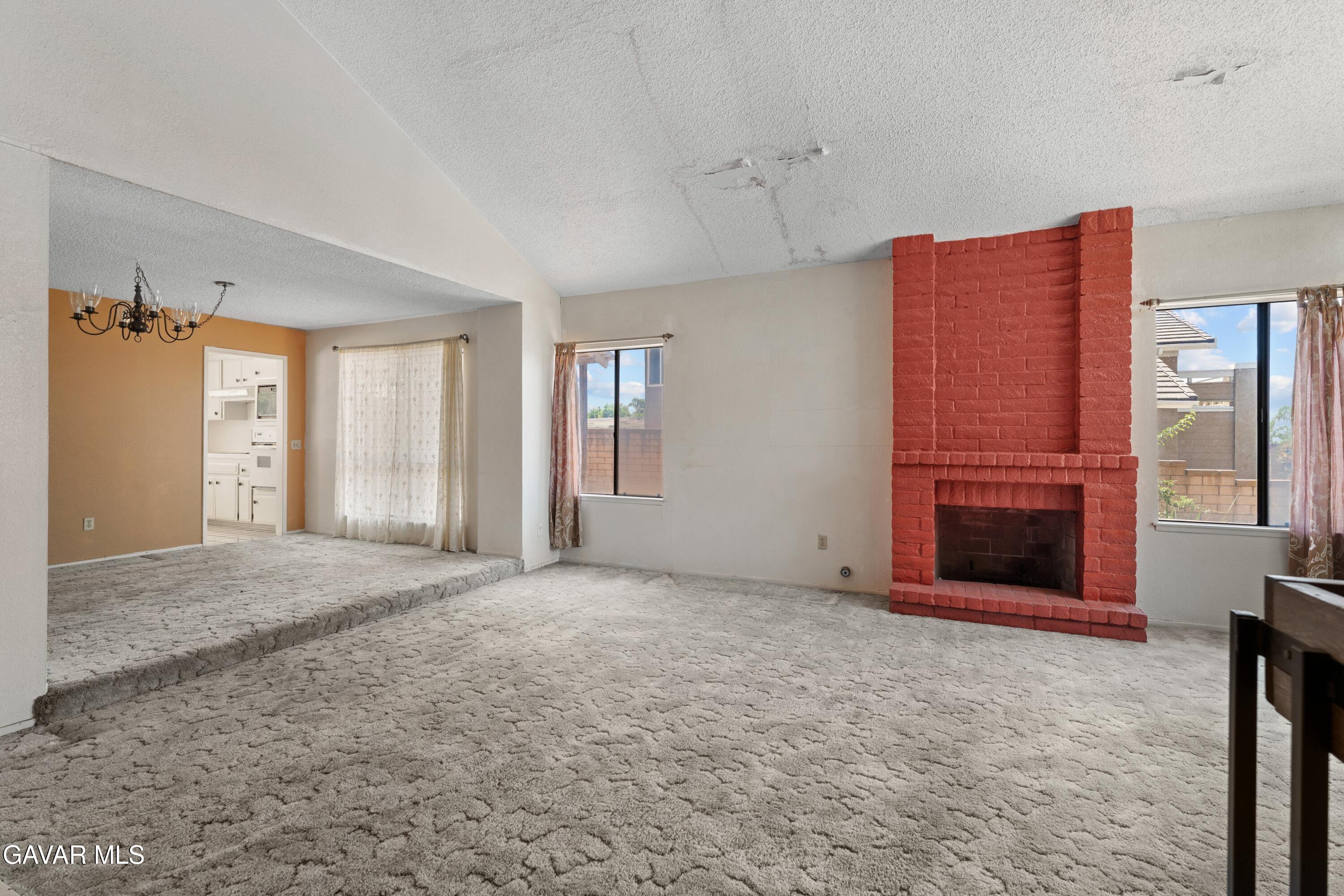 6113 Sard Street Rancho Cucamonga, CA 91701 - Photo 4 of 26 an empty room with windows and fireplace