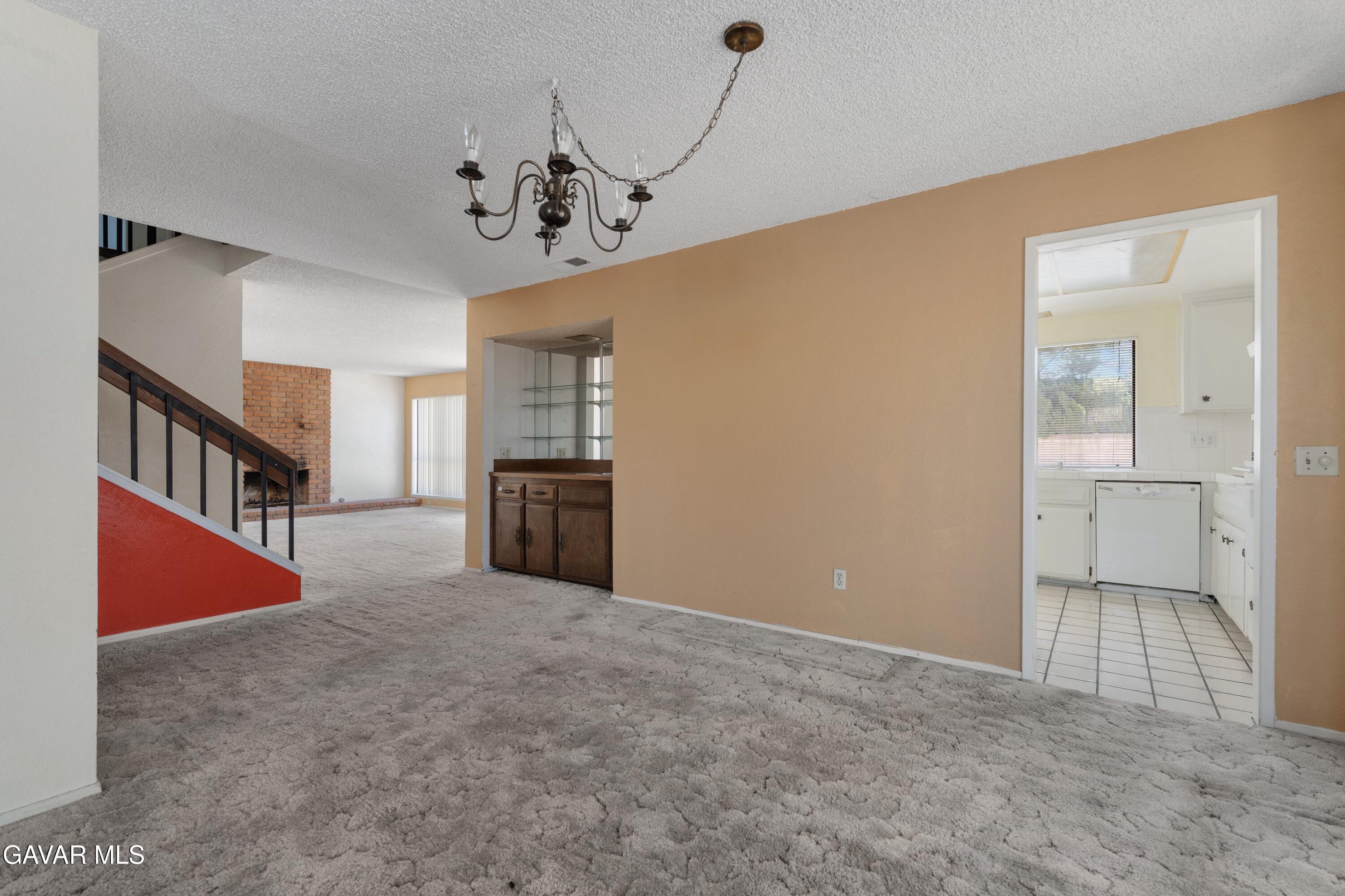 6113 Sard Street Rancho Cucamonga, CA 91701 - Photo 5 of 26 a view of a hallway with a kitchen
