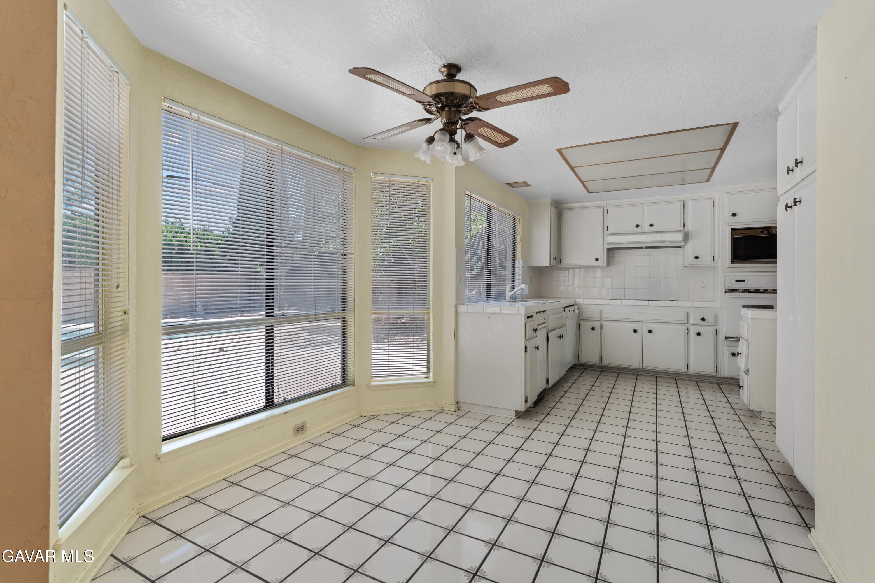 6113 Sard Street Rancho Cucamonga, CA 91701 - Photo 8 of 26 a view of a kitchen with a sink and a refrigerator
