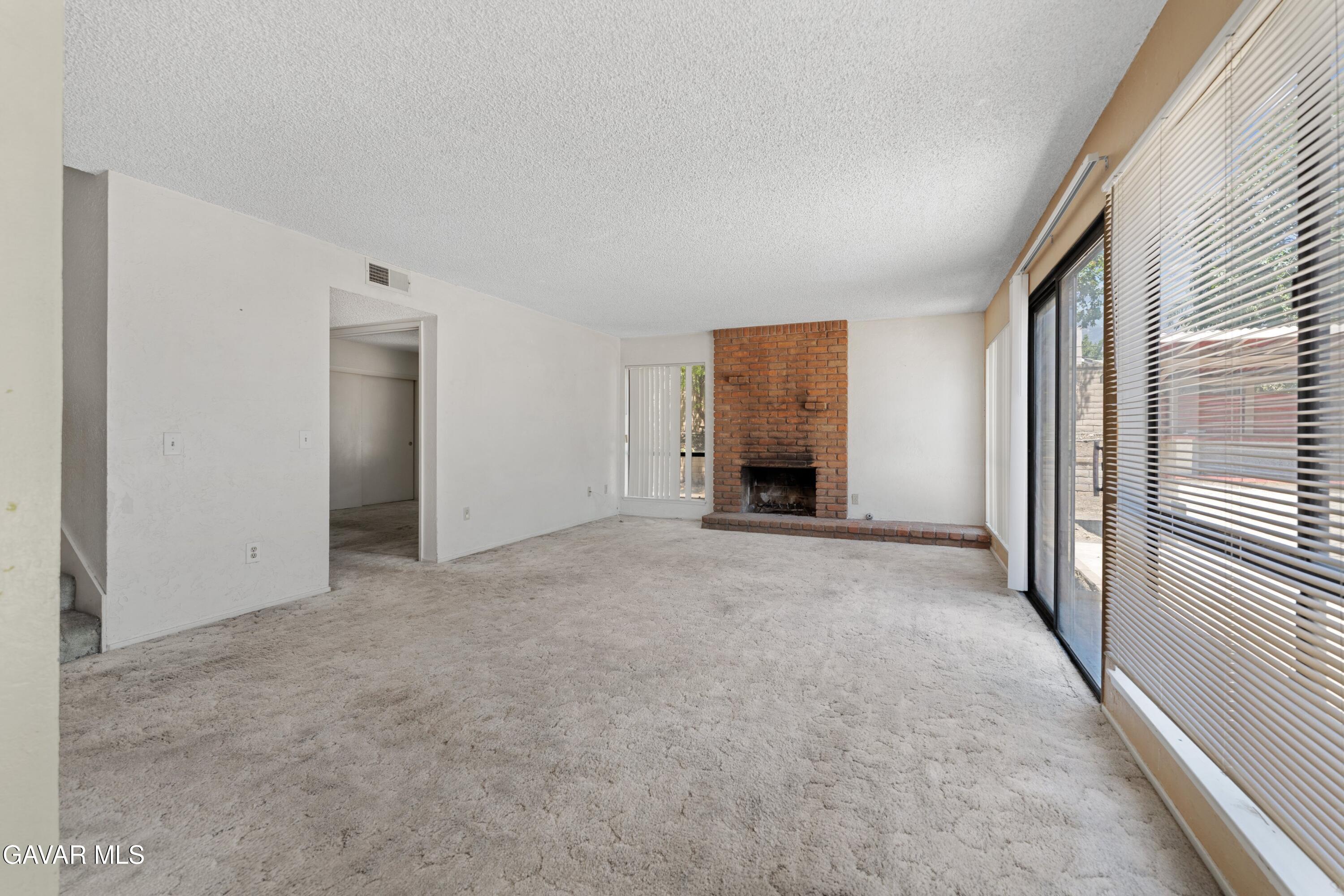 6113 Sard Street Rancho Cucamonga, CA 91701 - Photo 10 of 26 an empty room with windows and a ceiling fan
