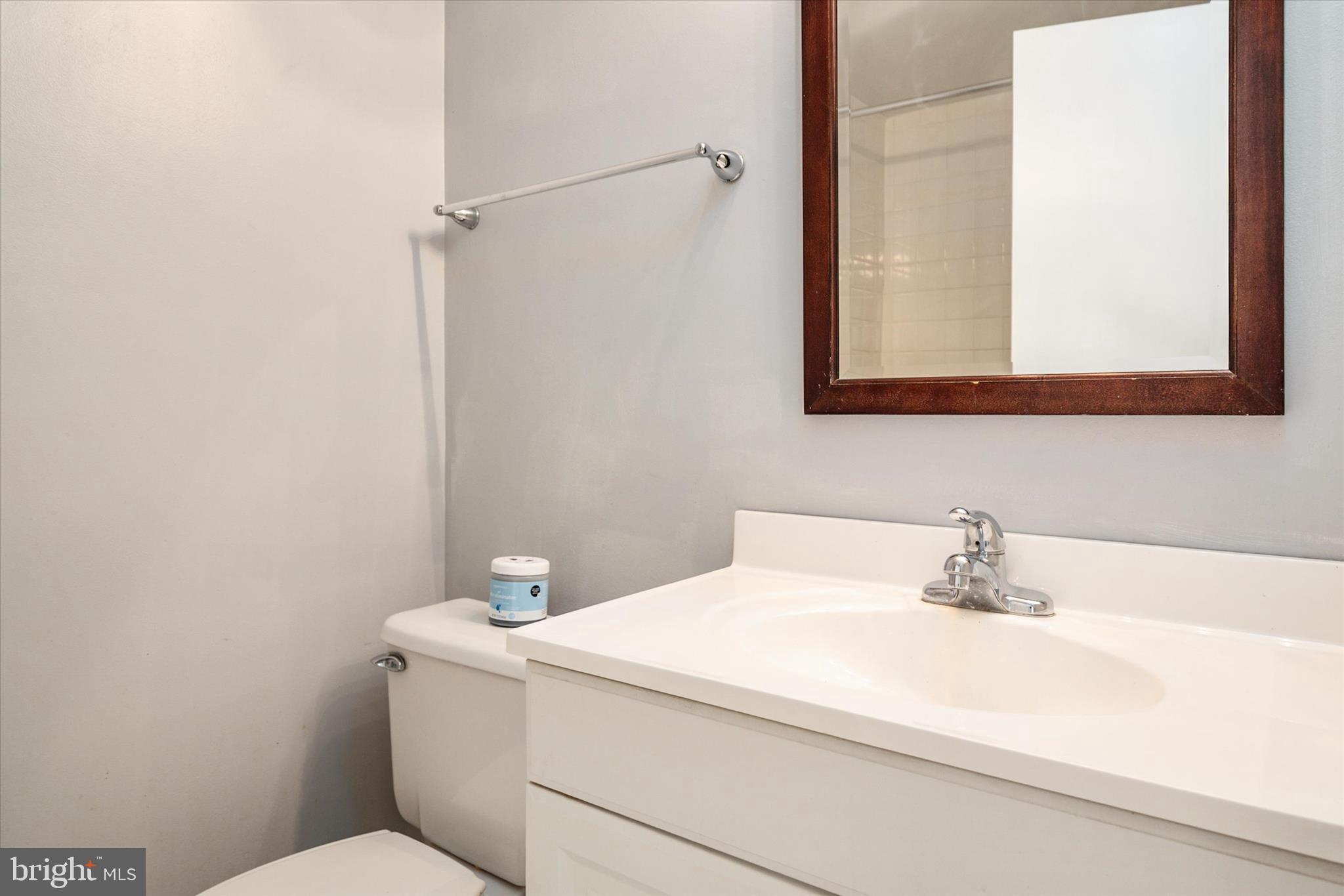 28 Allegheny Avenue, Unit 2710 Towson, MD 21204 - Photo 27 of 40 a bathroom with a sink a toilet and mirror