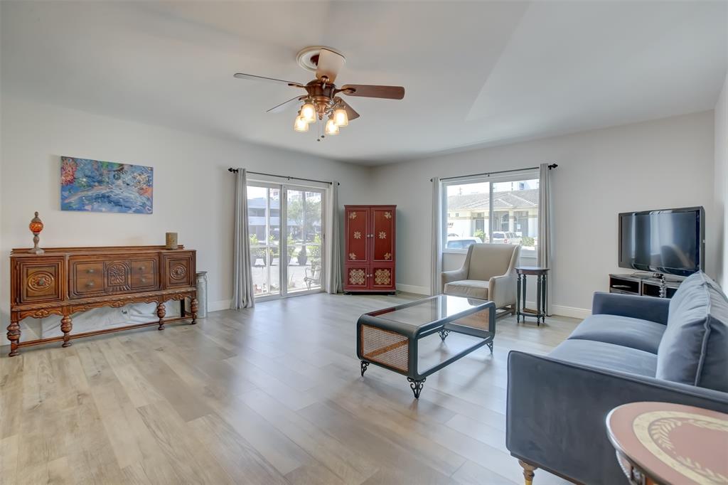 1450 North Riverside Drive, Unit 101 Pompano Beach, FL 33062 - Photo 11 of 52 a living room with furniture and a flat screen tv