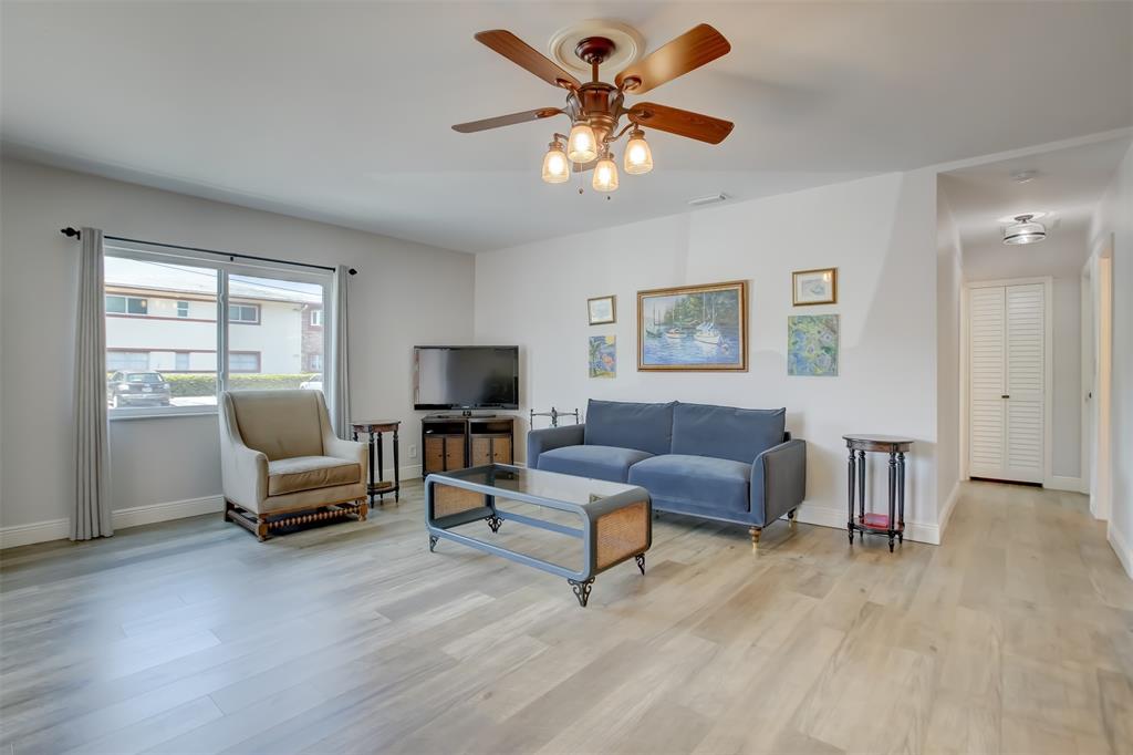 1450 North Riverside Drive, Unit 101 Pompano Beach, FL 33062 - Photo 13 of 52 a living room with furniture and a flat screen tv