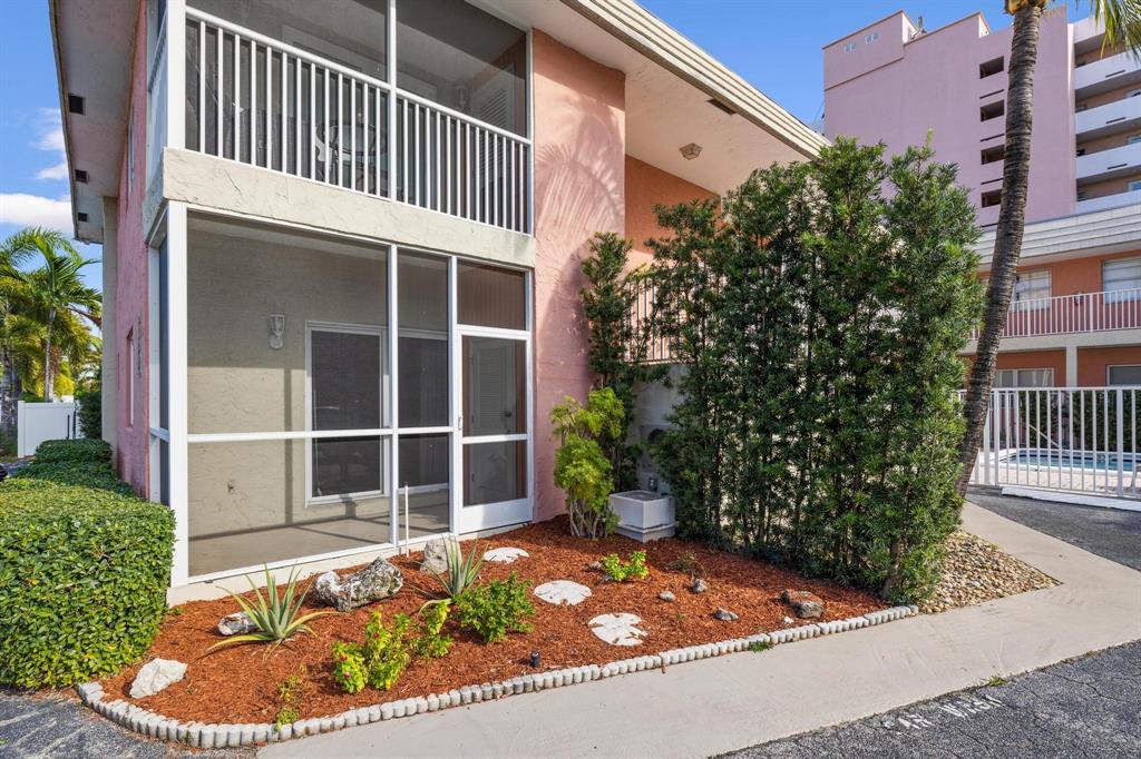 1450 North Riverside Drive, Unit 101 Pompano Beach, FL 33062 - Photo 2 of 52 a house view with a garden space