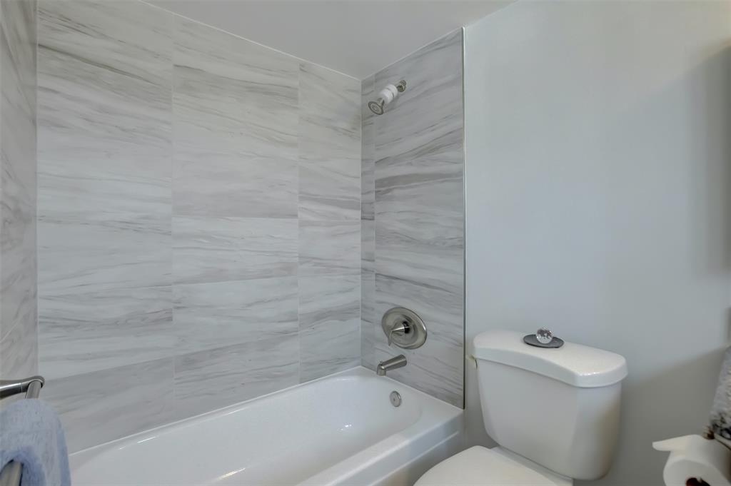 1450 North Riverside Drive, Unit 101 Pompano Beach, FL 33062 - Photo 23 of 52 a bathroom with a toilet and a bathtub