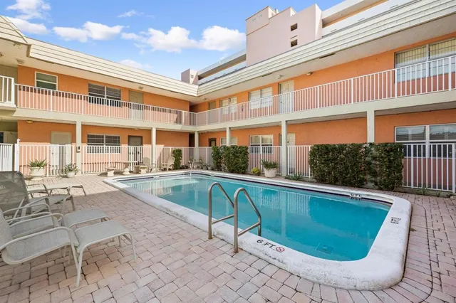 a view of a swimming pool with a lounge chair